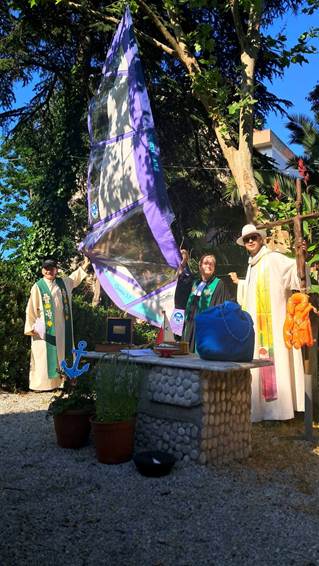 The image shows three people dressed in ceremonial attire, standing outdoors near a tree with a decorative structure, under a clear blue sky.

AI-generated content may be incorrect.