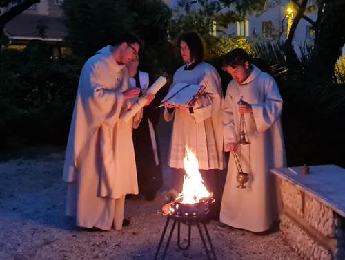 A group of people in robes standing around a fire

AI-generated content may be incorrect.