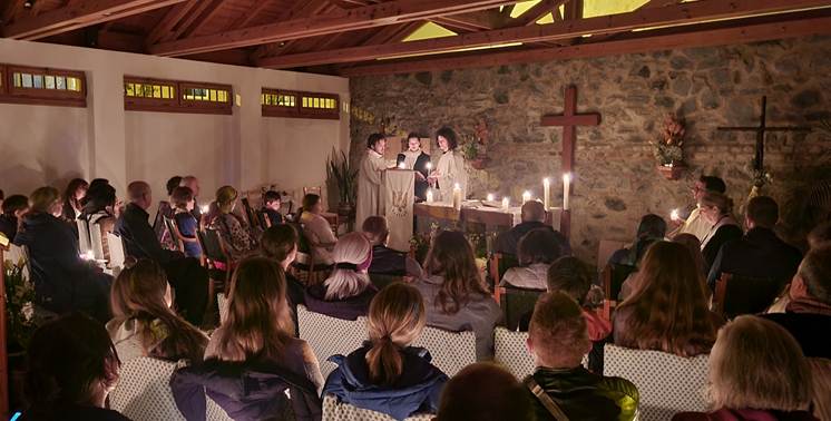 A group of people in a room with a cross and a cross

AI-generated content may be incorrect.