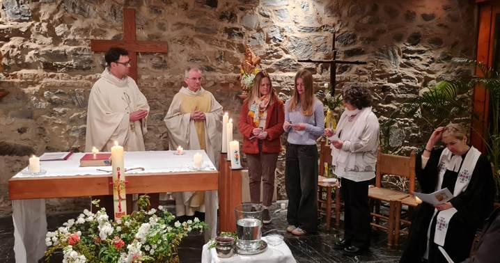 A group of people standing in a church

AI-generated content may be incorrect.